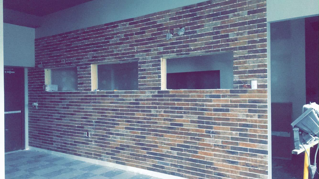 Brick accent wall with three recessed openings