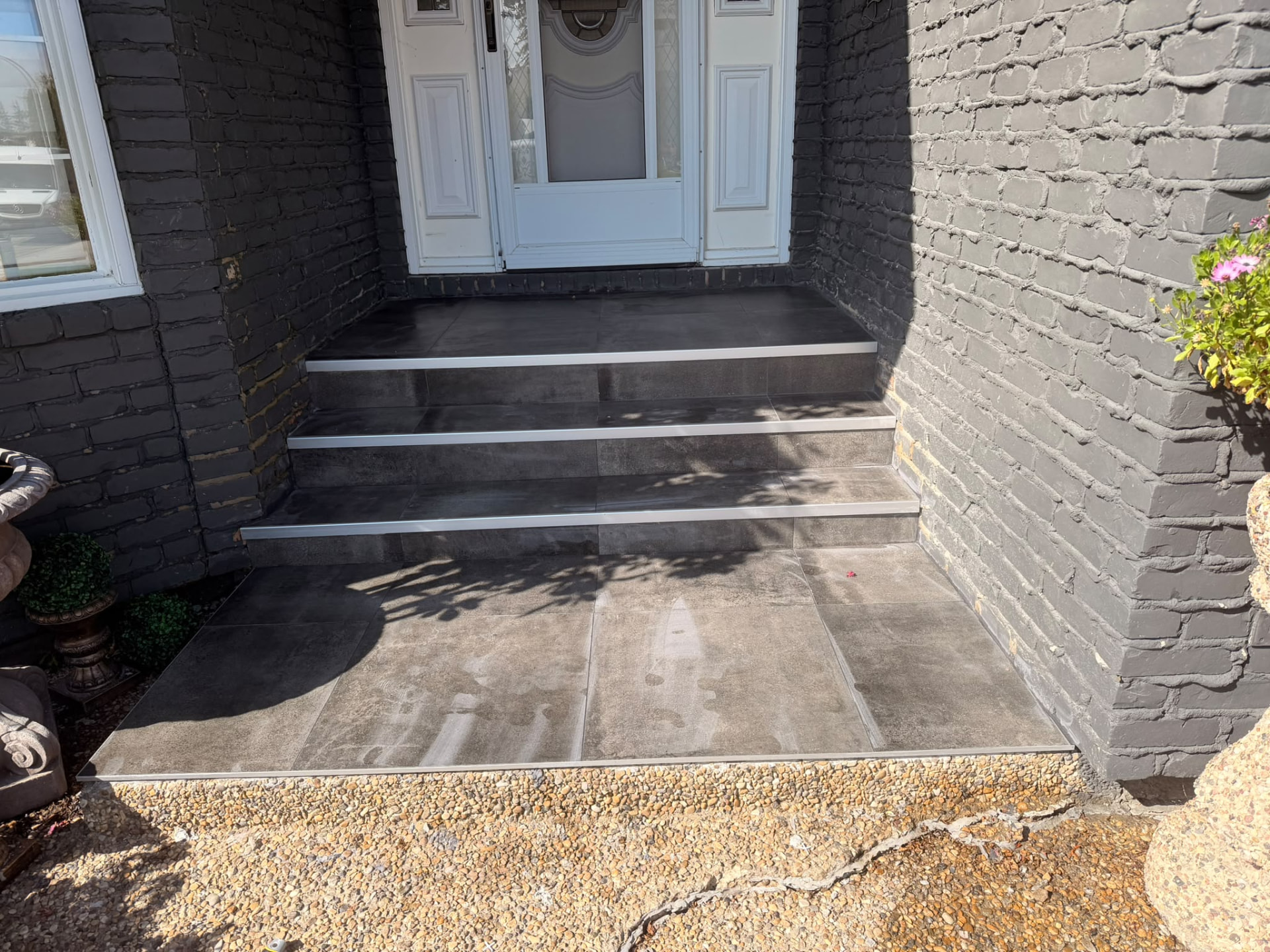 Tiled front entry landing and steps