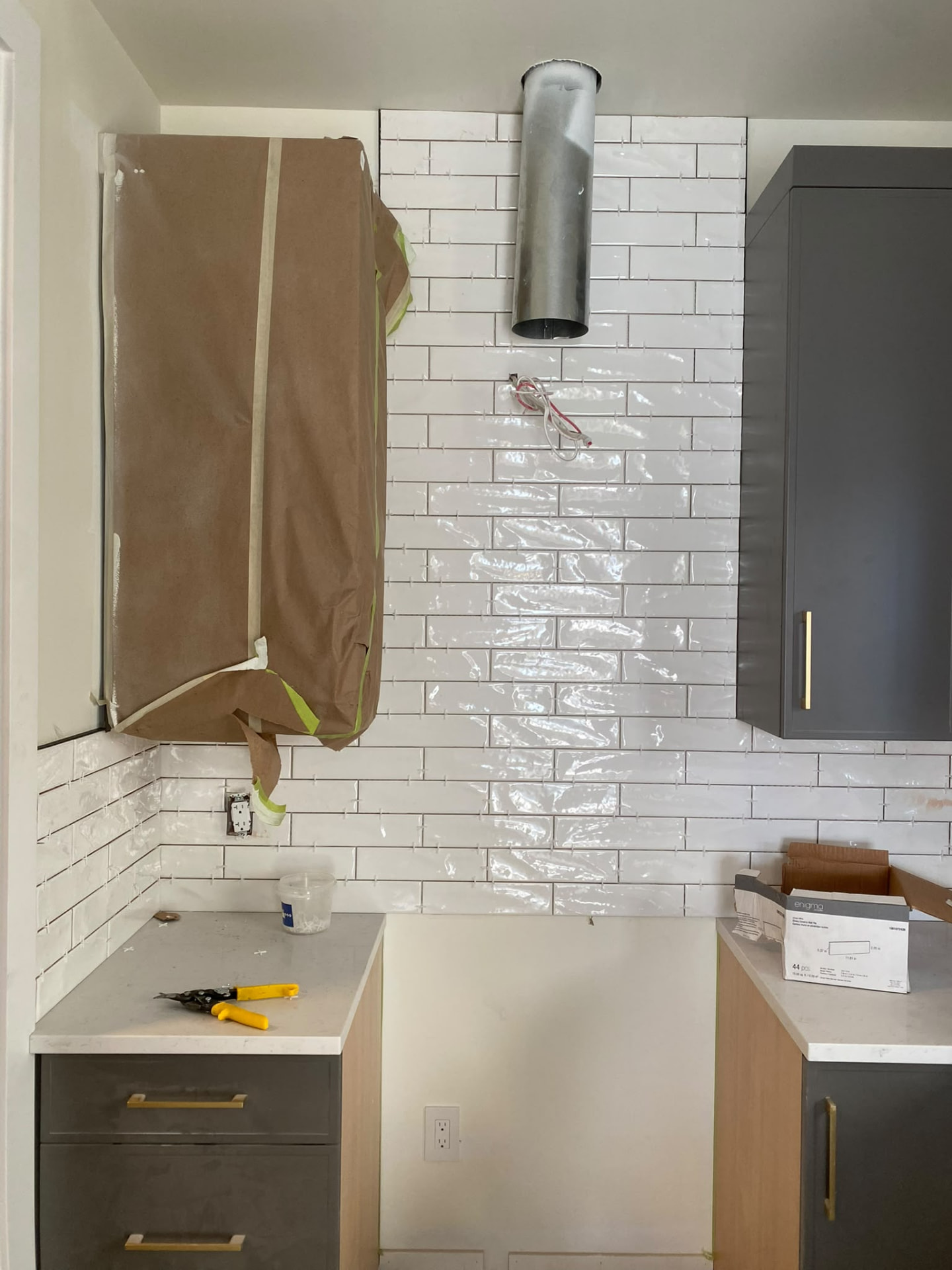 White bathroom wall tiles beside the vanity