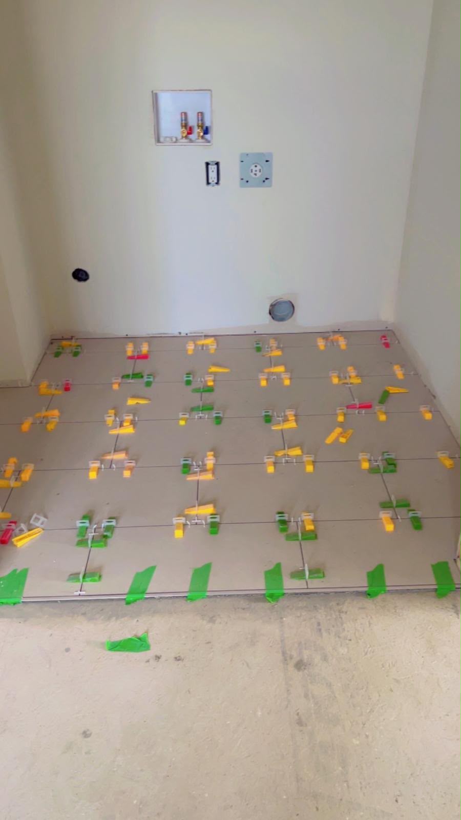 Floor tile installation with leveling clips in place