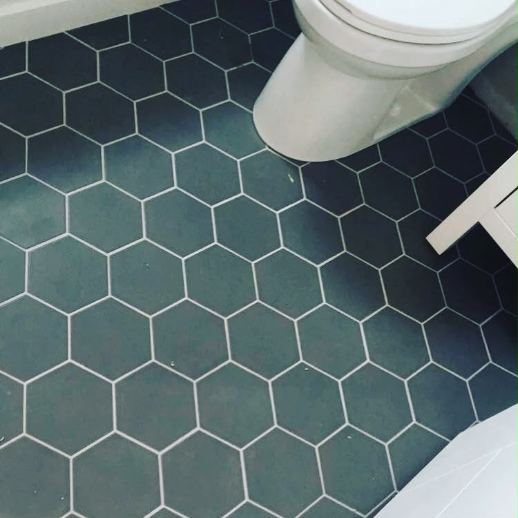 Dark hexagonal bathroom floor tiles